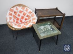 A 20th century wicker tub chair on metal hairpin legs together with an oak two tier trolley and a