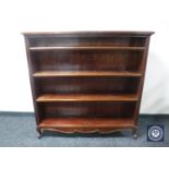 A set of early twentieth century mahogany open bookshelves