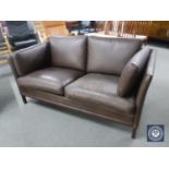 A mid 20th century brown leather two seater settee