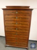 A continental mahogany seven drawer chest on paw feet,