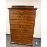 A continental mahogany seven drawer chest on paw feet,