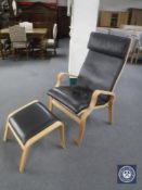 A high backed beech framed leather armchair and matching stool