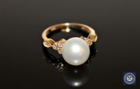 A 14ct yellow gold pearl and diamond ring, the white,