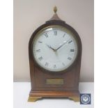 A 20th century inlaid mahogany mantel clock with lion mask handles by Comitti of London on brass