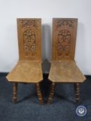A pair of carved oak hall chairs