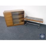 A set of teak sliding glass door bookshelves fitted a cupboard together with a teak tiled top table