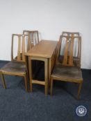 A late 20th century teak drop leaf table together with four chairs