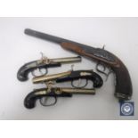 A reproduction flintlock pistol and three further similar small pistols (4)