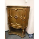 A period style carved oak corner cabinet,