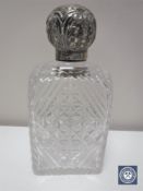 A silver topped cut crystal perfume bottle