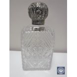 A silver topped cut crystal perfume bottle