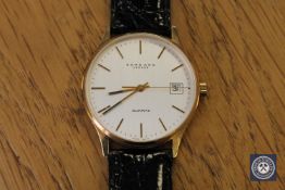 A gent's 9ct gold centre seconds calendar wristwatch, signed Garrard, quartz movement,