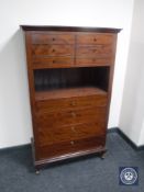 A twentieth century teak chest fitted with ten drawers