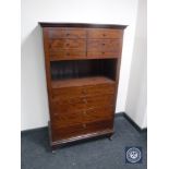 A twentieth century teak chest fitted with ten drawers