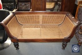 A Regency style mahogany and bergere settee