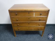 A mid twentieth century walnut four drawer chest