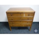 A mid twentieth century walnut four drawer chest