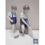 Two Royal Copenhagen figures depicting children by the seaside,