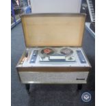 A Carousel reel to reel player with instruction manual and mic.