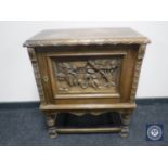 A continental carved oak cupboard