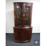 A reproduction double door corner display cabinet