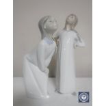 Two Lladro figures; Girl with hands on hips and Girl blowing kiss,