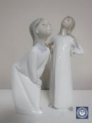 Two Lladro figures; Girl with hands on hips and Girl blowing kiss,