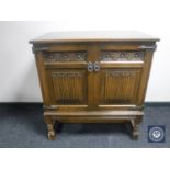 An oak linen fold double door cabinet CONDITION REPORT: 90cm wide by 53cm deep by