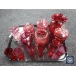 A tray of antique and later cranberry glass jugs, pots,