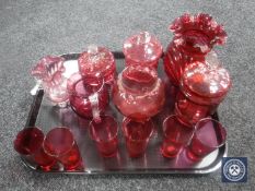 A tray of antique and later cranberry glass jugs, pots,