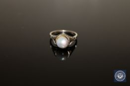 An early twentieth century pearl ring mounted in white metal stamped 18K, size I.