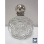 A silver topped cut crystal perfume bottle