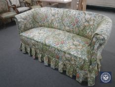 An early 20th century settee in floral fabric