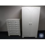 A contemporary white double door wardrobe together with matching six drawer chest