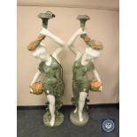 An impressive pair of carved marble figural floor lamps of maidens holding flowers,