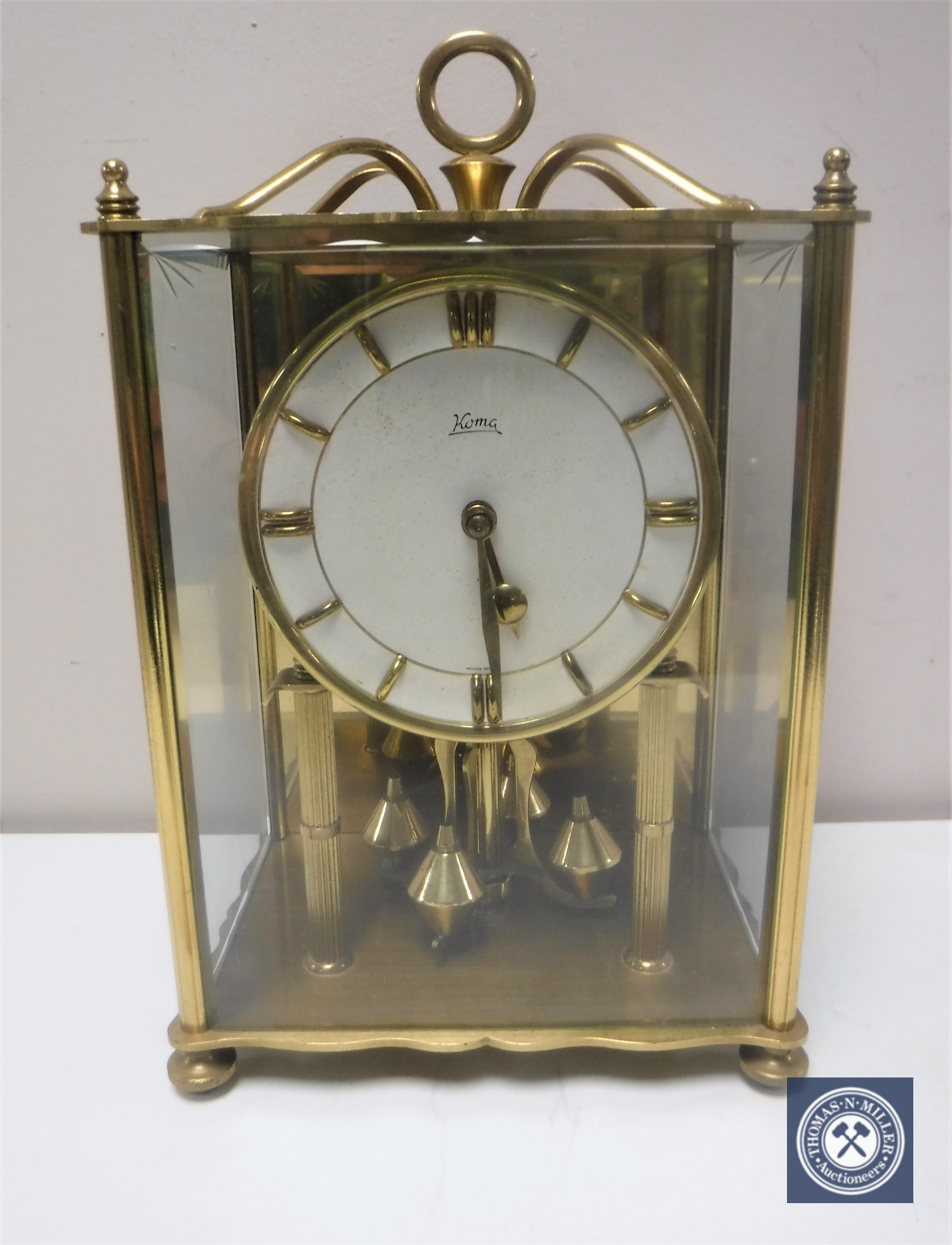 A brass and glass panelled Koma mantel clock