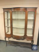 A Victorian inlaid mahogany bowfront display cabinet fitted a drawer,
