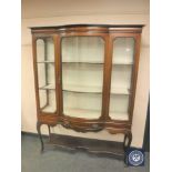 A Victorian inlaid mahogany bowfront display cabinet fitted a drawer,