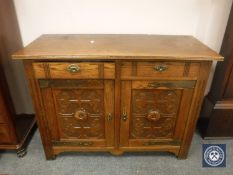 An Edwardian oak sideboard fitted two drawers,