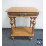 An antique pine occasional table fitted with a drawer and undershelf