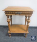 An antique pine occasional table fitted with a drawer and undershelf