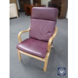 A beech framed armchair in maroon leather