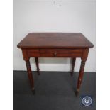 An early 20th century kitchen table fitted a drawer
