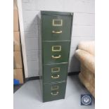 A vintage metal four drawer filing cabinet