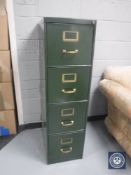 A vintage metal four drawer filing cabinet