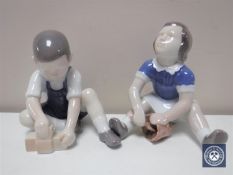 Two Bing and Grondahl figures depicting children seated,
