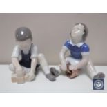 Two Bing and Grondahl figures depicting children seated,