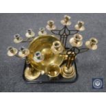 A tray of brass candlesticks, two chargers,