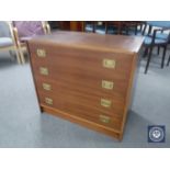 A mid 20th century Danish four drawer chest with brass drop handles