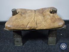 A leather seated camel stool